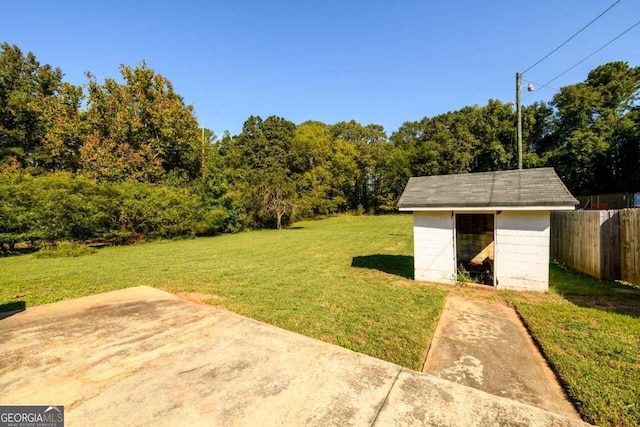 view of yard featuring a patio area and a storage unit