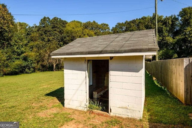 view of outbuilding featuring a lawn