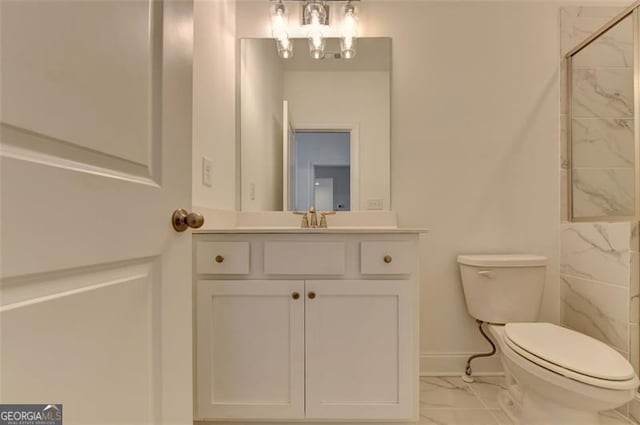 bathroom featuring a shower, vanity, and toilet