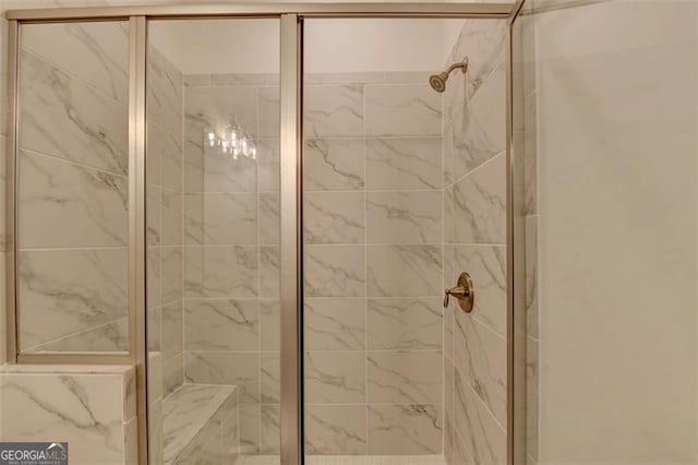 bathroom featuring a shower with door