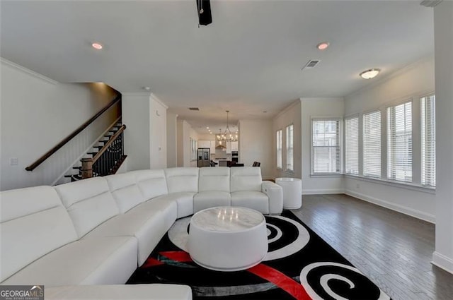 living room with dark wood-type flooring and a notable chandelier