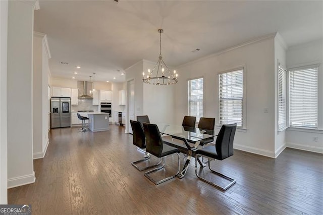 dining room featuring a chandelier, dark wood-type flooring, a wealth of natural light, and ornamental molding