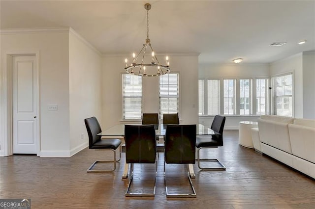 dining area featuring dark wood-type flooring, an inviting chandelier, and crown molding