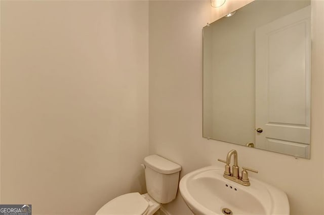 bathroom featuring toilet and sink