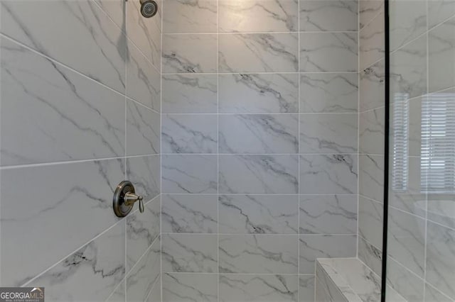 bathroom with a tile shower