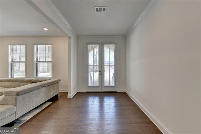 doorway to outside featuring dark hardwood / wood-style flooring, crown molding, and french doors