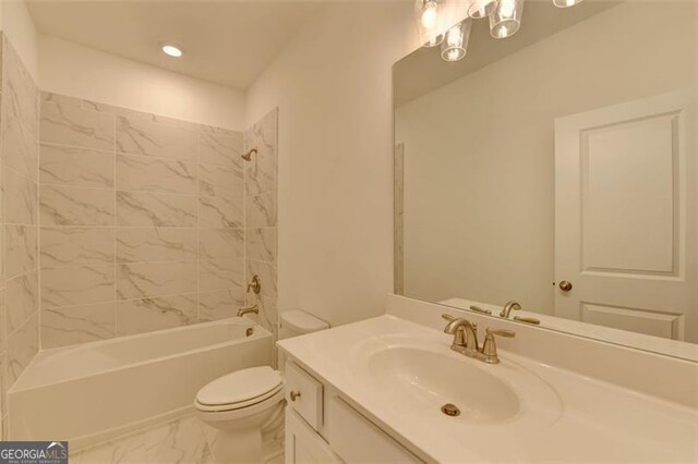 full bathroom with vanity, toilet, and tiled shower / bath