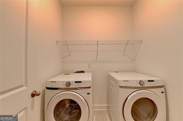 laundry area with light tile patterned flooring and separate washer and dryer