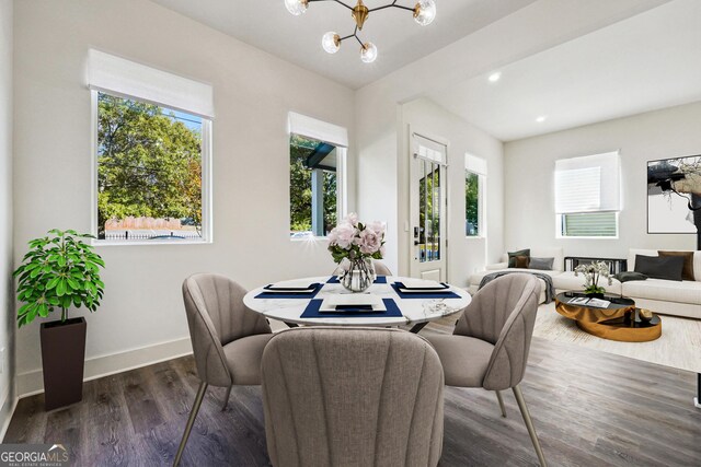 dining space featuring dark wood-style floors, recessed lighting, baseboards, and an inviting chandelier