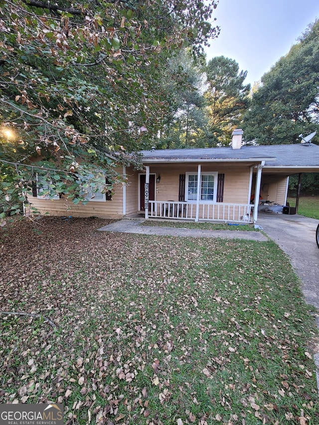 view of front of home with covered porch and a carport