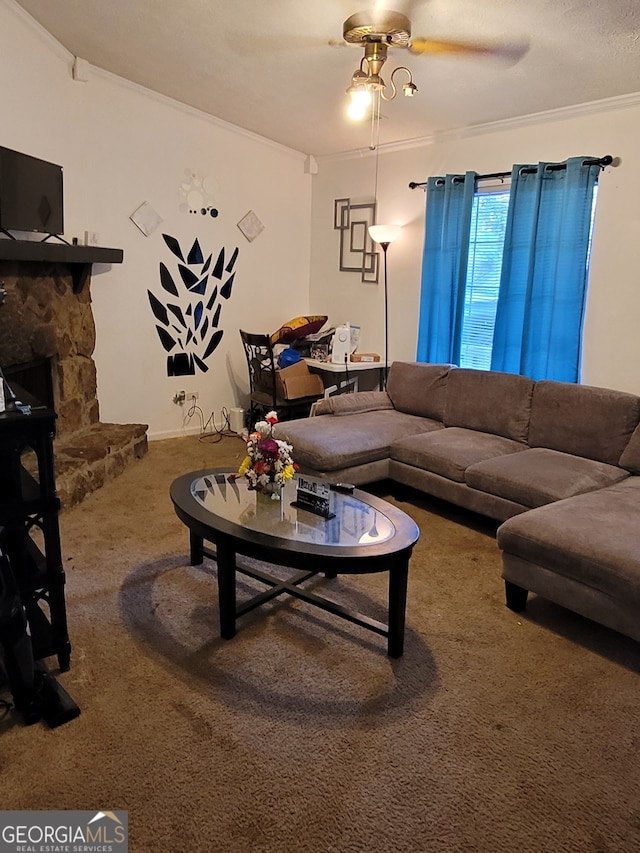 carpeted living room with ornamental molding, a stone fireplace, a textured ceiling, and ceiling fan