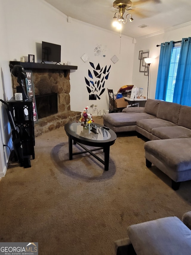 carpeted living room featuring a stone fireplace, ornamental molding, and ceiling fan