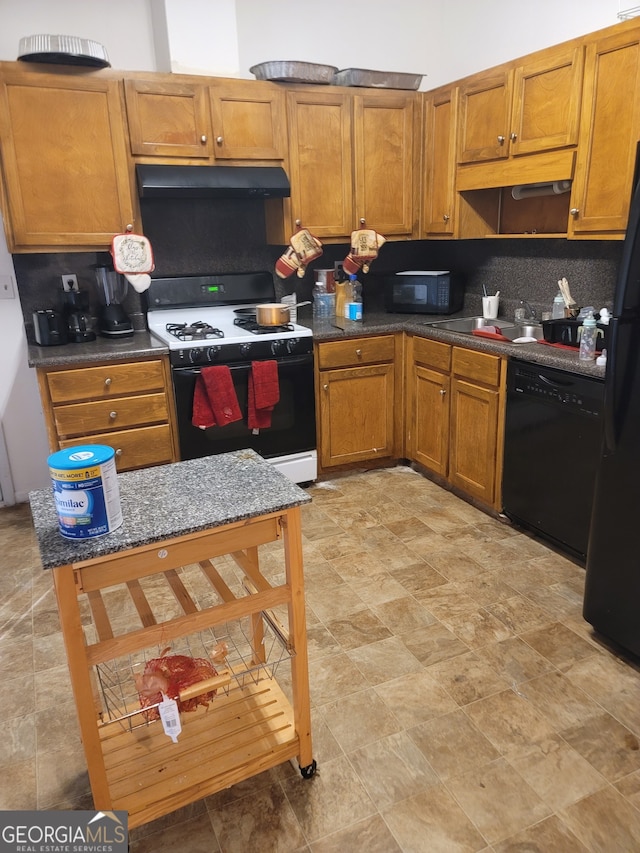 kitchen with sink, black appliances, and backsplash