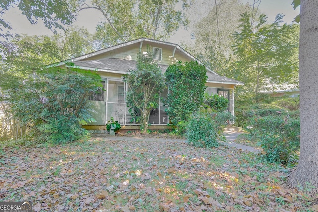 view of property exterior featuring a sunroom