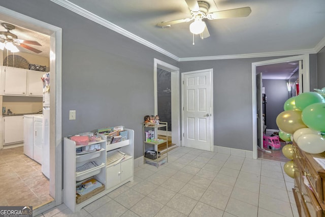 playroom with ornamental molding, light tile patterned floors, washer and clothes dryer, and ceiling fan