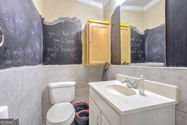 bathroom with vanity, toilet, crown molding, and tile walls