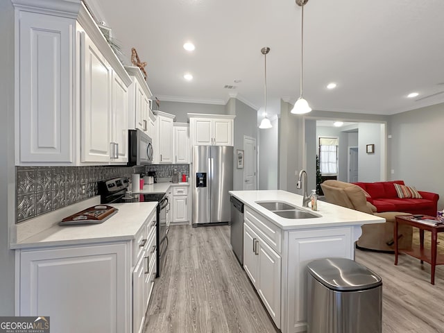 kitchen featuring pendant lighting, sink, white cabinets, and appliances with stainless steel finishes