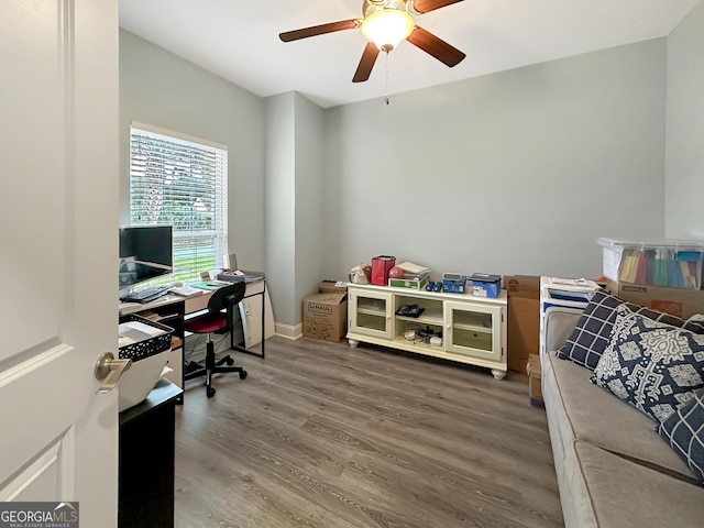 home office with hardwood / wood-style flooring and ceiling fan