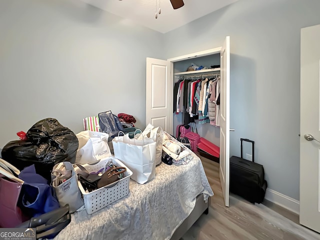 bedroom featuring wood-type flooring, a closet, and ceiling fan