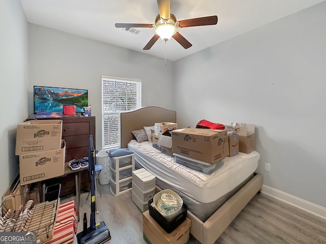 bedroom with ceiling fan and light hardwood / wood-style flooring