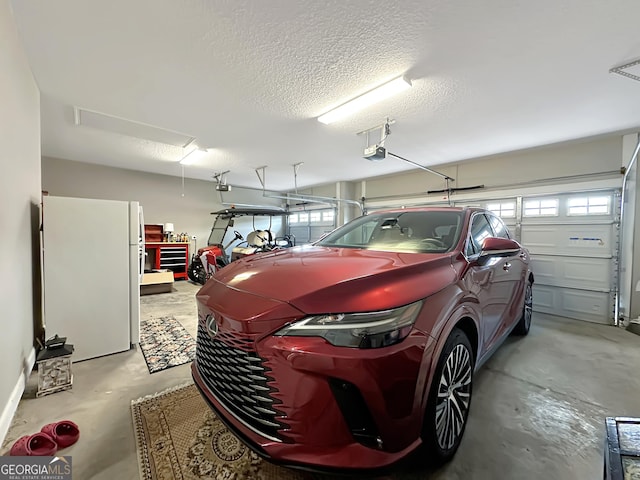 garage featuring a garage door opener and white fridge