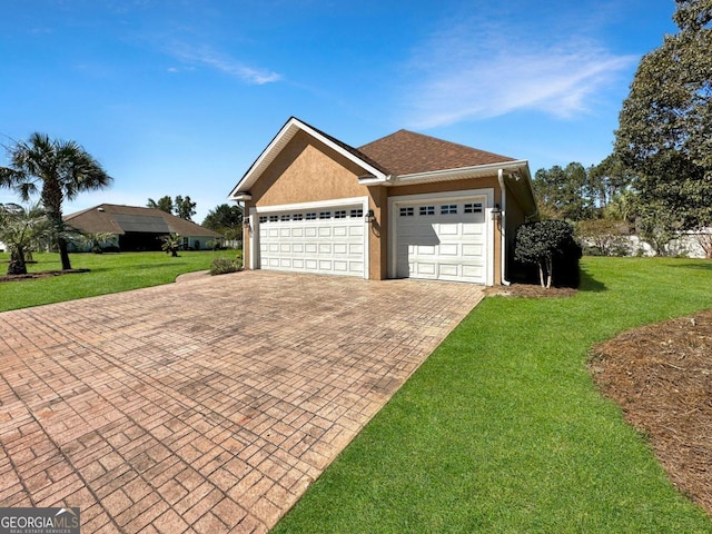 view of front of property with a garage and a front yard