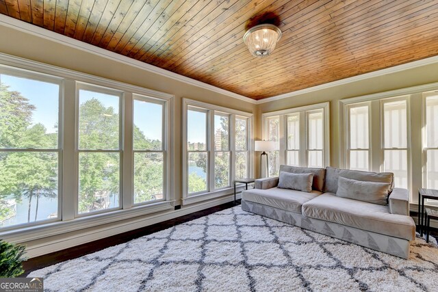 sunroom with a water view and wooden ceiling