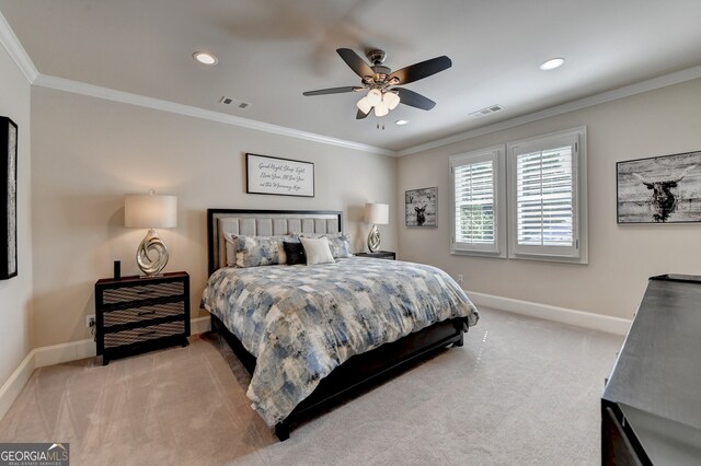 bedroom featuring ornamental molding, light carpet, and ceiling fan