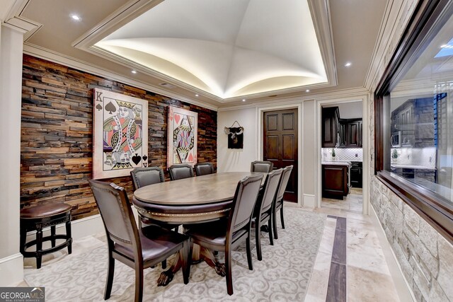 dining room featuring ornamental molding and a tray ceiling