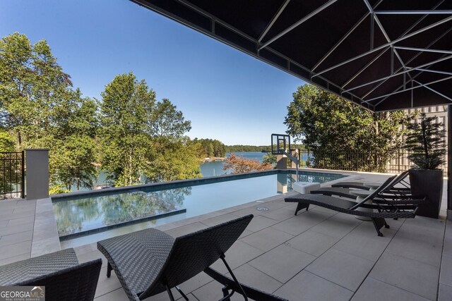 view of swimming pool featuring a water view and a patio area