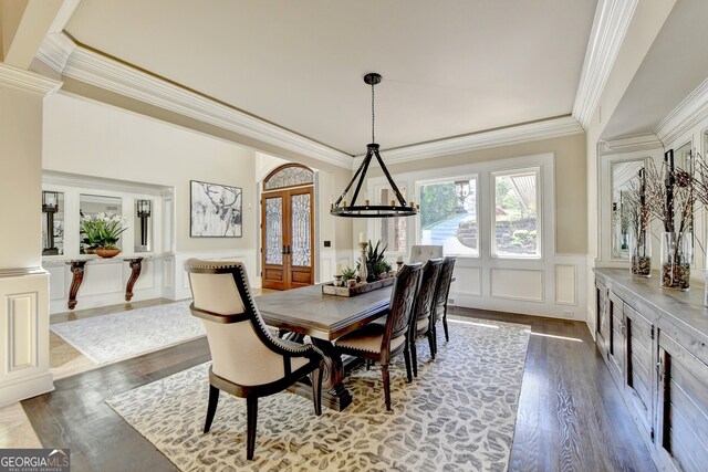 dining room featuring an inviting chandelier, crown molding, french doors, and hardwood / wood-style flooring