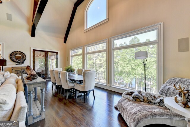 dining area with dark wood-type flooring, high vaulted ceiling, beamed ceiling, and a wealth of natural light