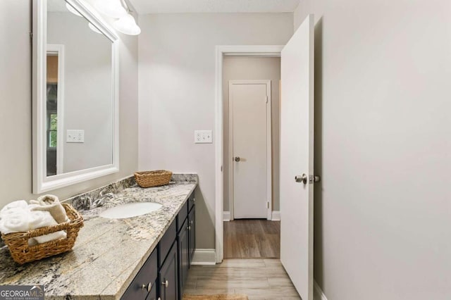 bathroom featuring vanity and hardwood / wood-style flooring