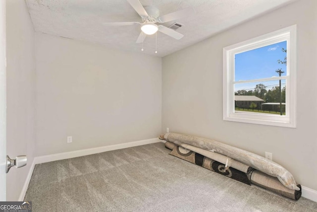 spare room with carpet flooring, a textured ceiling, and ceiling fan