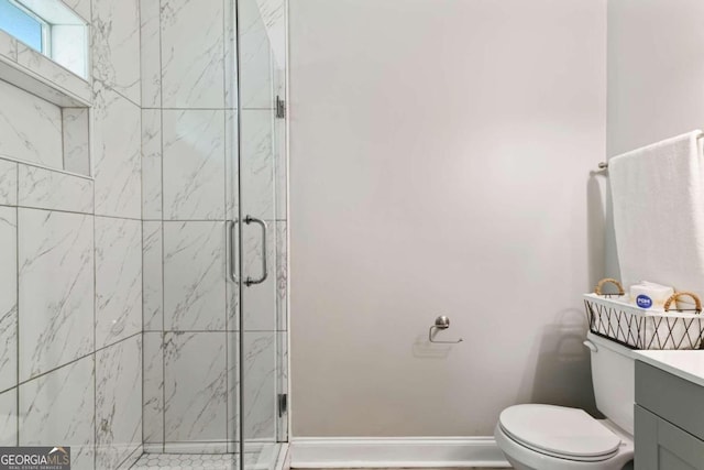 bathroom with vanity, an enclosed shower, and toilet