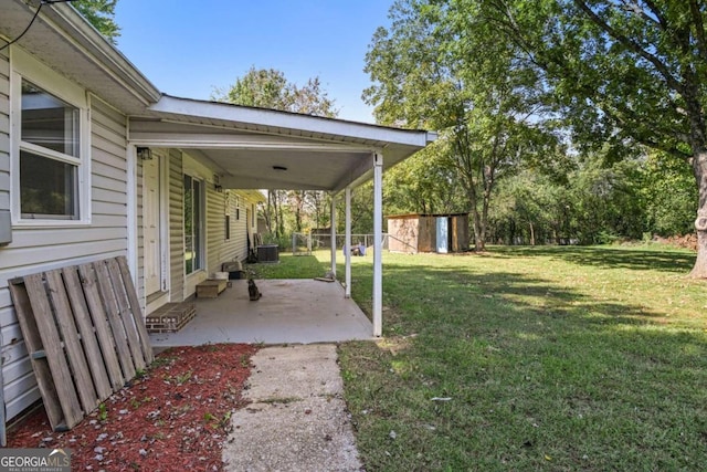 view of yard with a patio, a storage shed, and central air condition unit