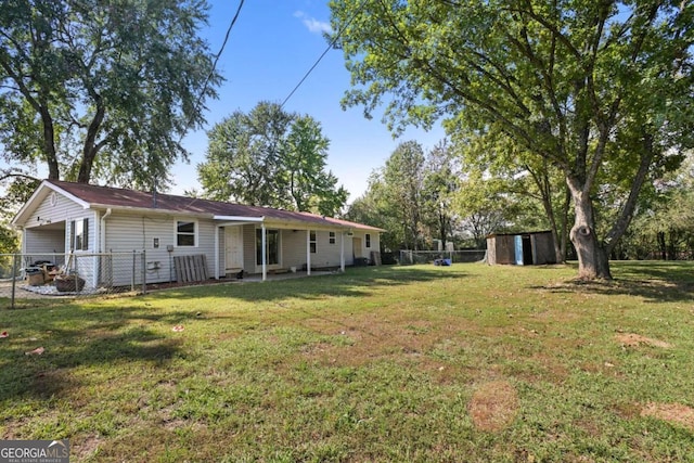 view of yard featuring a storage unit and a patio area