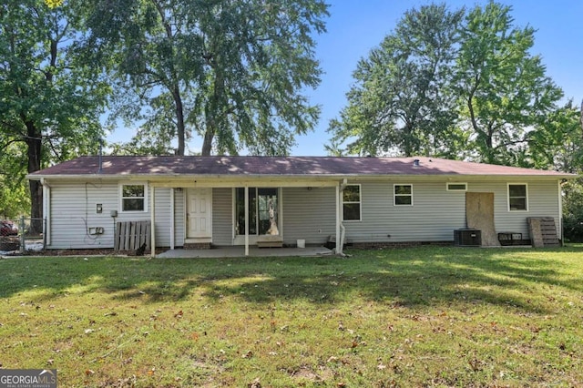 back of house with a yard, central air condition unit, and a patio area