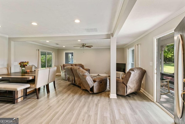 living room featuring ceiling fan, ornamental molding, and light wood-type flooring