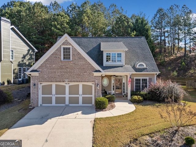 view of front of property featuring a garage and a front lawn