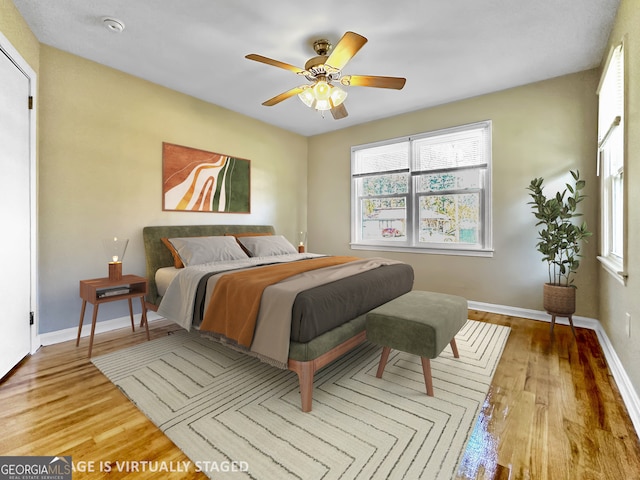 bedroom with light hardwood / wood-style floors and ceiling fan