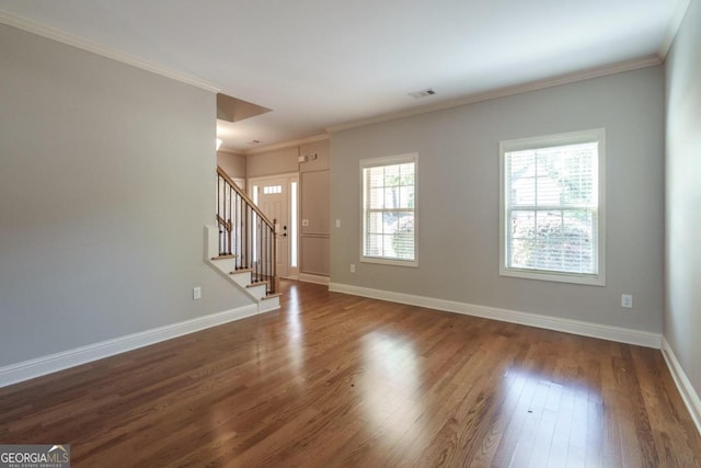 unfurnished living room with ornamental molding and dark wood-type flooring