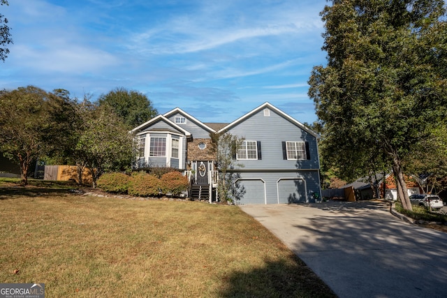 split foyer home with a front yard and a garage