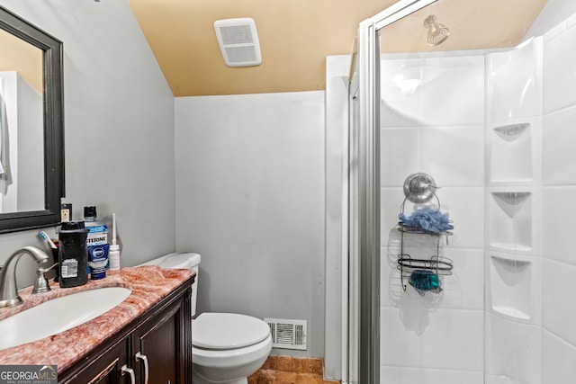 bathroom with a shower with door, toilet, lofted ceiling, and vanity