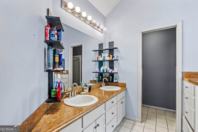 bathroom with vanity, tile patterned floors, and lofted ceiling