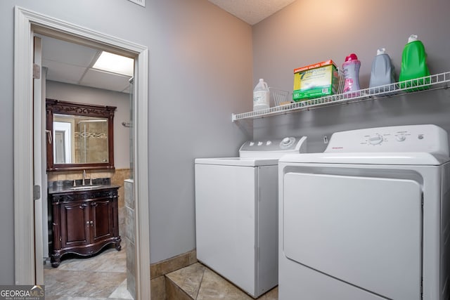 laundry room featuring sink and separate washer and dryer