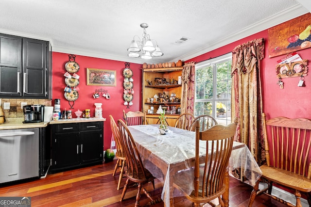 dining area with crown molding, dark wood-type flooring, and an inviting chandelier