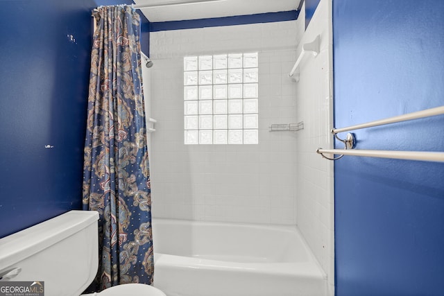 bathroom with shower / bath combination with curtain and toilet