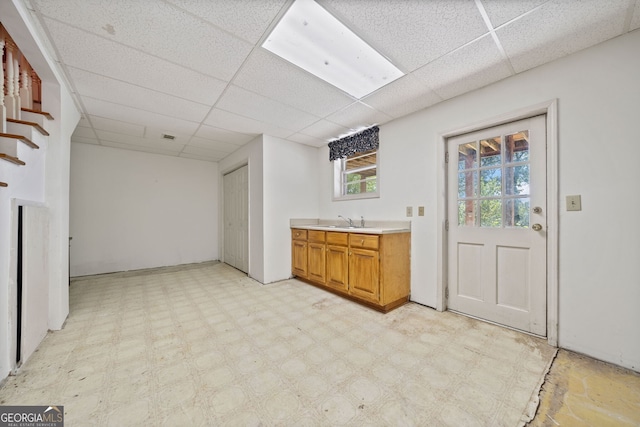 kitchen featuring a drop ceiling and sink