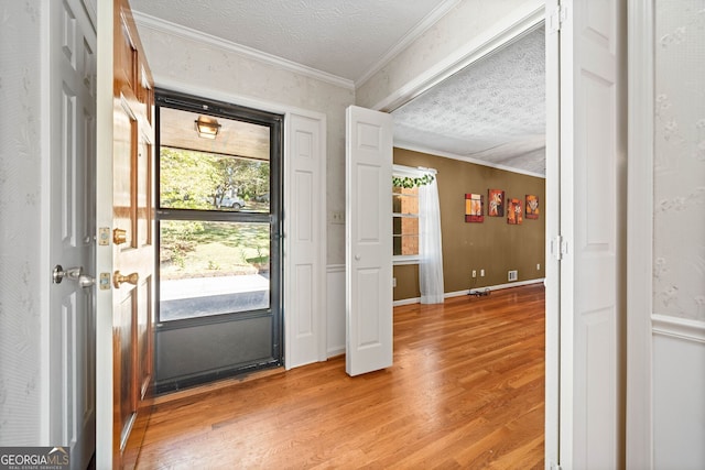 entrance foyer featuring crown molding, wood-type flooring, and a textured ceiling